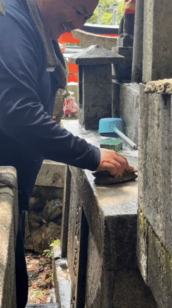 Scrubbing down a stone monument in Kyoto