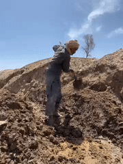 Construction workers dig trenches in Kandahar excavation project