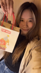Woman spotted with Pop Mart bag, later indoors in Yuzhong