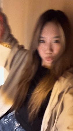 Woman spotted with Pop Mart bag, later indoors in Yuzhong
