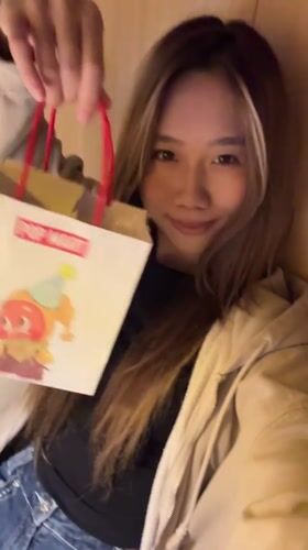 Woman spotted with Pop Mart bag, later indoors in Yuzhong