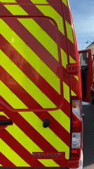 Fire trucks stationed on wet street in Bischheim France