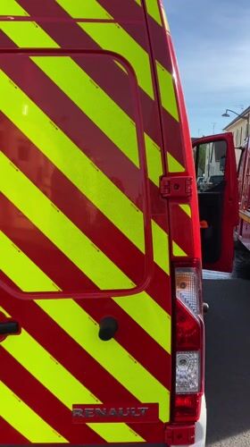 Fire trucks stationed on wet street in Bischheim France