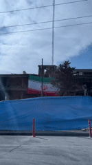 Damaged building with Iranian flag observed in Tehran