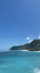Helicopter hovers over Kuta Selatan beach in early morning