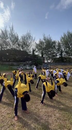 Students in uniform at a Lhokseumawe sports field