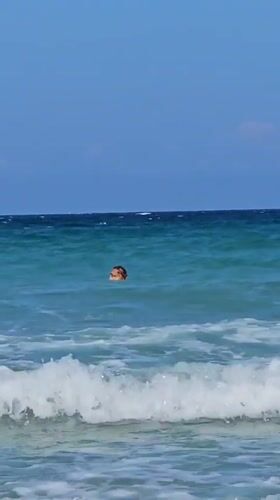 Beachgoers enjoy sunny morning waters at Cam Lam Vietnam