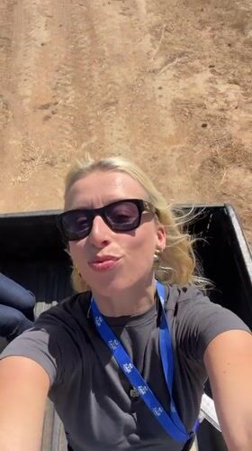 Woman with badge stands in pickup truck bed in Morocco