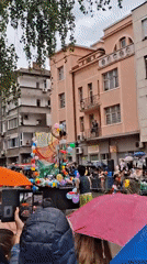 Rain-soaked parade with floats and performers draws crowds in Gabrovo