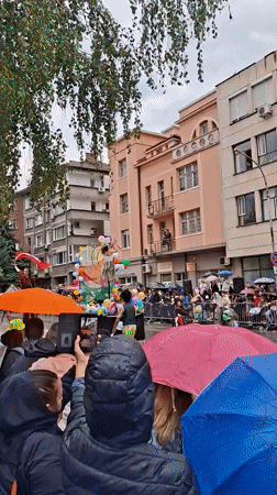 Rain-soaked parade with floats and performers draws crowds in Gabrovo