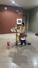 Woman plays harp in Sofia building hallway