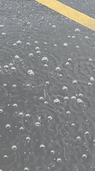 Raindrops captured on wet Moscow street pavement