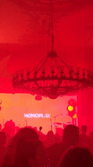 MONOPLAY band performs nighttime outdoor concert under red lights