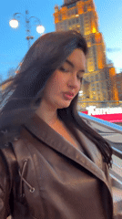 Woman photographed near Moscow hotel amid architectural documentation