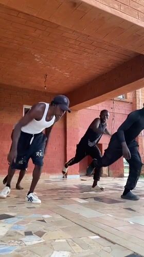 Young men perform synchronized dance routine in Vom, Nigeria