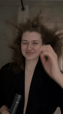 Woman captured mid-hair styling routine in Kazan