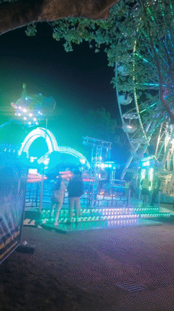 Night carnival operates with illuminated rides in Rastatt, Germany