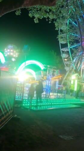 Night carnival operates with illuminated rides in Rastatt, Germany