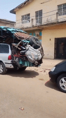 Bicycle repair shop activity documented with overloaded vehicle nearby
