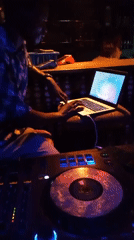 Live music night at dimly lit club with DJ, drums