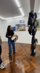 Gallery visitors view artwork in Buenos Aires evening exhibition