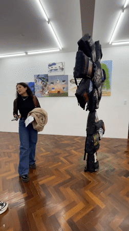 Gallery visitors view artwork in Buenos Aires evening exhibition