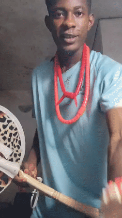 Ceremonial regalia and crown in a dimly lit Nigerian room