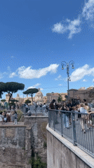 Tourist documents Roman Forum views on sunny May morning