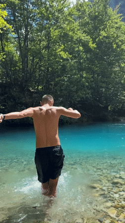 Swimming and wading in turquoise river waters in Vusanje