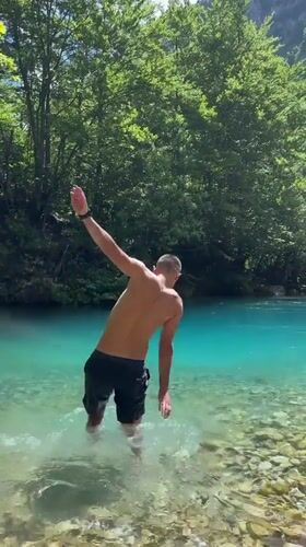 Swimming and wading in turquoise river waters in Vusanje