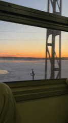 Train passenger documents sunset over frozen water in Russia