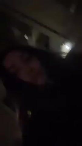 A very dark video shows a person's face. The person appears to be lying down.