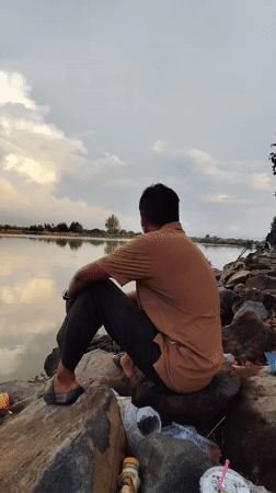 Fishing from the rocks on a cloudy afternoon