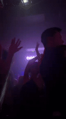 Nightclub patrons dance under laser lights at Paris venue