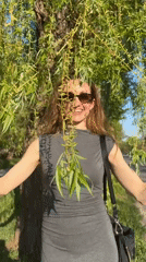 Woman enjoys spring blooms in Kryvyi Rih park area