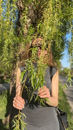 Woman enjoys spring blooms in Kryvyi Rih park area
