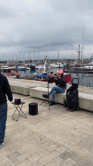 Ordinary life unfolds across A Coruña's streets and harbor