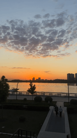 Kazan evening scenes: sunset skyline and Tesla near Ferris wheel