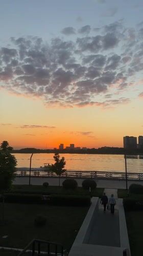 Kazan evening scenes: sunset skyline and Tesla near Ferris wheel