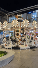 Zebra-themed carousel operates at night in Baan Chaweng, Thailand