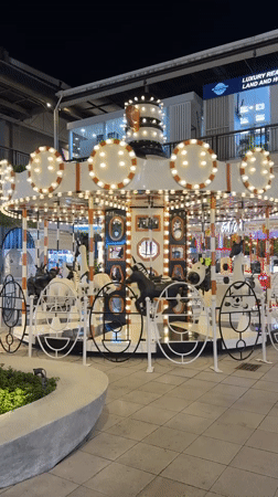 Zebra-themed carousel operates at night in Baan Chaweng, Thailand