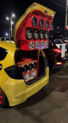 Young men gather around cars with speaker systems in Arica
