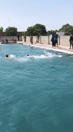 Men and boys enjoy morning swim at Samundri pool