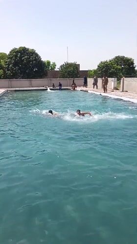 Men and boys enjoy morning swim at Samundri pool