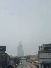 Commuter documents Dubai metro journey through urban cityscape