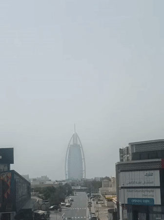 Commuter documents Dubai metro journey through urban cityscape