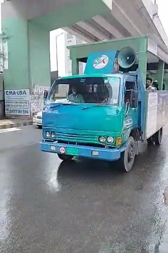 Modified truck spotted on wet Dhaka street under overpass