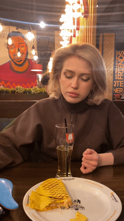 Woman dining alone at restaurant in Ufa, Russia