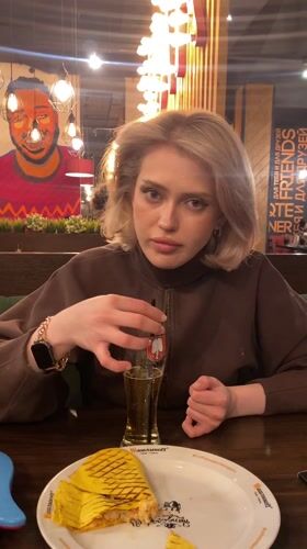 Woman dining alone at restaurant in Ufa, Russia