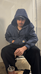 Young man smoking outdoors with food in Vila Real